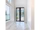 Elegant entryway with marble floors and black-framed doors at 1020 Jack Nicklaus Ct, Kissimmee, FL 34747