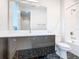 Bathroom with dark geometric floor tile and floating vanity at 1020 Jack Nicklaus Ct, Kissimmee, FL 34747