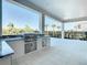 Outdoor kitchen with granite countertop and stainless steel appliances at 1020 Jack Nicklaus Ct, Kissimmee, FL 34747