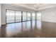 Main bedroom with dark hardwood floors and access to a private balcony at 1020 Jack Nicklaus Ct, Kissimmee, FL 34747