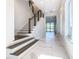 Stunning staircase with white risers and dark wood treads leading to the second floor at 1020 Jack Nicklaus Ct, Kissimmee, FL 34747