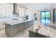 Modern kitchen with gray cabinets and white marble countertops at 1020 Jack Nicklaus Ct, Kissimmee, FL 34747