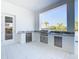 Outdoor kitchen with granite countertop and stainless steel appliances at 1020 Jack Nicklaus Ct, Kissimmee, FL 34747