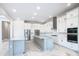 Gourmet kitchen featuring a large island, stainless steel appliances, and marble flooring at 1020 Jack Nicklaus Ct, Kissimmee, FL 34747