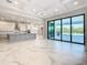 Modern kitchen with marble floors, island, and access to patio at 1020 Jack Nicklaus Ct, Kissimmee, FL 34747