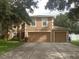 Two-story house with a large driveway and attached garage at 15507 Willet Ct, Mascotte, FL 34753