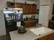 Kitchen with stainless steel refrigerator and island at 15507 Willet Ct, Mascotte, FL 34753