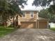 Two-story house with a two-car garage and a well-maintained lawn at 15507 Willet Ct, Mascotte, FL 34753