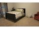 Bedroom with a queen-size bed and teal curtains at 15507 Willet Ct, Mascotte, FL 34753