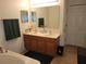 Double vanity bathroom with a large mirror and garden tub at 15507 Willet Ct, Mascotte, FL 34753