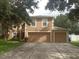 Two-story house with a two-car garage and a well-maintained lawn at 15507 Willet Ct, Mascotte, FL 34753