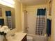 Bathroom with single vanity and shower/tub combo at 15507 Willet Ct, Mascotte, FL 34753