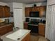 Kitchen with stainless steel appliances and ample counter space at 15507 Willet Ct, Mascotte, FL 34753
