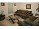Cozy living room featuring a comfy sofa and coffee table at 15507 Willet Ct, Mascotte, FL 34753