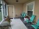 Screened porch with seating and grill at 15507 Willet Ct, Mascotte, FL 34753