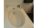 Oval garden bathtub with a modern faucet at 15507 Willet Ct, Mascotte, FL 34753