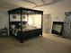 Main bedroom with canopy bed and full-length mirror at 15507 Willet Ct, Mascotte, FL 34753