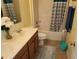 Bathroom with double vanity and shower/tub combo at 15507 Willet Ct, Mascotte, FL 34753