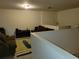 Spacious bonus room with a couch and view of the lower floor at 15507 Willet Ct, Mascotte, FL 34753