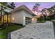 Modern garage with glass doors and stylish landscaping at 210 Chelton Cir, Winter Park, FL 32789