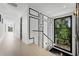 Elegant hallway with light hardwood floors and large window at 210 Chelton Cir, Winter Park, FL 32789