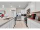 Modern kitchen with stainless steel appliances and granite counters at 1001 Rivers Crossing St, Clermont, FL 34714