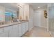 Elegant bathroom with double vanity, granite countertops, and a large walk-in shower at 1001 Rivers Crossing St, Clermont, FL 34714