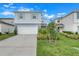 Two-story house with a two-car garage and nicely landscaped yard at 1001 Rivers Crossing St, Clermont, FL 34714