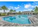 Relaxing community pool with surrounding lounge chairs and shaded seating at 1001 Rivers Crossing St, Clermont, FL 34714