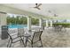 Covered patio area with seating overlooking the community pool at 1001 Rivers Crossing St, Clermont, FL 34714