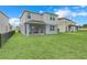 Large backyard with grassy area and screened porch at 1001 Rivers Crossing St, Clermont, FL 34714
