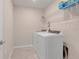 Convenient laundry room with washer, dryer, and overhead shelving at 1001 Rivers Crossing St, Clermont, FL 34714