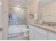 Clean bathroom with a tub shower combo, granite vanity, and updated fixtures at 1001 Rivers Crossing St, Clermont, FL 34714