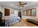 Spacious bedroom with wood floors, large windows, and ceiling fan at 8605 Bay Shore Cv, Orlando, FL 32836