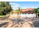Two-story house with tile roof, large driveway, and landscaping at 8605 Bay Shore Cv, Orlando, FL 32836