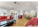 Living room with red and beige sofas, and views into the kitchen at 8605 Bay Shore Cv, Orlando, FL 32836