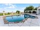 Inviting pool with stone coping and lake views at 8605 Bay Shore Cv, Orlando, FL 32836