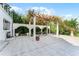 Elegant patio with pergola, fountain, and ample seating area at 8605 Bay Shore Cv, Orlando, FL 32836