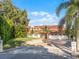Two-story house with tile roof, large driveway, and landscaping at 8605 Bay Shore Cv, Orlando, FL 32836