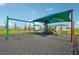 Playground with swings, shade structure, and playset at 3579 Dahlia Dr, Lake Hamilton, FL 33851