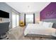 Relaxing main bedroom featuring a king bed, desk, and access to a balcony at 8889 Cabot Cliffs Dr # 104, Davenport, FL 33896