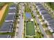 Aerial view of a community with homes, a park, and sports facilities at 8889 Cabot Cliffs Dr # 104, Davenport, FL 33896