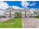 Modern three-unit townhome with driveway and landscaping at 8889 Cabot Cliffs Dr # 104, Davenport, FL 33896
