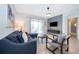 Open living room featuring a sectional sofa, accent chair, and a modern TV wall at 8889 Cabot Cliffs Dr # 104, Davenport, FL 33896