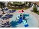 Community splash pad with water features and lounge chairs at 8889 Cabot Cliffs Dr # 104, Davenport, FL 33896
