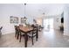 Modern dining room with a large wooden table and six chairs at 8889 Cabot Cliffs Dr # 104, Davenport, FL 33896