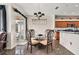 Bright dining area with a glass table and four chairs, near kitchen at 2907 Sunset Lakes Blvd, Kissimmee, FL 34747