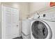 Bright laundry room, features washer, dryer, and ample shelving at 2907 Sunset Lakes Blvd, Kissimmee, FL 34747