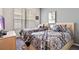 Two twin beds with patterned bedding and a large window at 2907 Sunset Lakes Blvd, Kissimmee, FL 34747