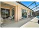 Covered patio with sliding glass doors leading to the pool area at 2907 Sunset Lakes Blvd, Kissimmee, FL 34747